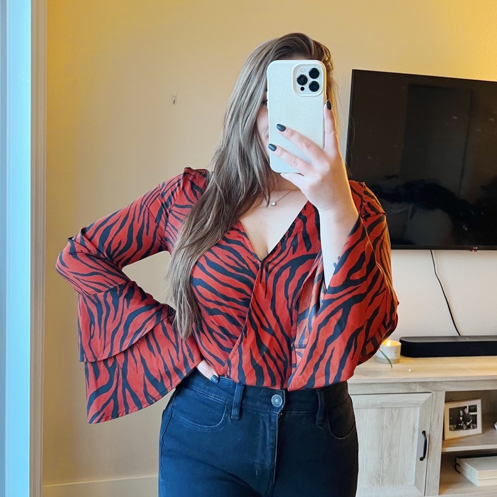 Burnt orange zebra print Express bodysuit with bell sleeves